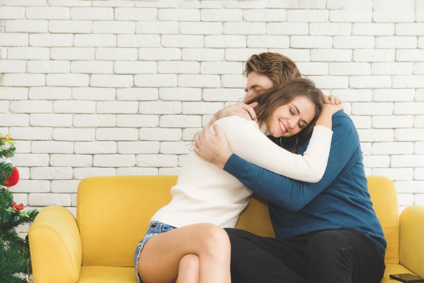 A professional cuddler happily hugging a client, offering comforting and non-sexual touch therapy to support emotional healing and well-being